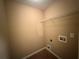Functional laundry room with shelving and utility connections, ready for appliances at 606 Windcroft Nw Cir, Acworth, GA 30101