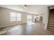 Spacious living room with abundant natural light, leading to the kitchen and staircase at 606 Windcroft Nw Cir, Acworth, GA 30101