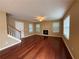 A spacious living room featuring hardwood floors, a fireplace, and a staircase leading to the upper level at 606 Windcroft Nw Cir, Acworth, GA 30101