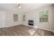 Bright living room featuring new floors, modern fireplace and lots of natural light from large windows at 606 Windcroft Nw Cir, Acworth, GA 30101