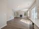 Open-concept living room with fireplace, large windows, and hardwood floors throughout at 606 Windcroft Nw Cir, Acworth, GA 30101