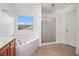 Bathroom featuring a tub, shower, and single vanity at 7454 Silver Arrow Se Trl, Austell, GA 30168
