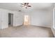 Bedroom with neutral carpet and adjacent bathroom and closet at 7454 Silver Arrow Se Trl, Austell, GA 30168