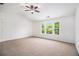 Spacious bedroom with vaulted ceiling and three windows allowing lots of natural light at 7454 Silver Arrow Se Trl, Austell, GA 30168