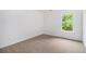 Simple bedroom provides ample light with a large window and neutral carpet at 7454 Silver Arrow Se Trl, Austell, GA 30168