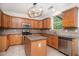 Spacious kitchen with stainless steel appliances, tile backsplash, and island with granite counters at 7454 Silver Arrow Se Trl, Austell, GA 30168