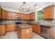 Bright kitchen features tile countertops, stainless steel appliances, tile flooring, and an island at 7454 Silver Arrow Se Trl, Austell, GA 30168