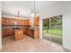 Open kitchen with tile floors, stainless appliances, granite counters and view to the backyard at 7454 Silver Arrow Se Trl, Austell, GA 30168