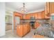 Well-lit kitchen with a center island, tile countertops, and ample cabinet space at 7454 Silver Arrow Se Trl, Austell, GA 30168