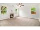 Bright living room with a ceiling fan, fireplace, and large windows at 7454 Silver Arrow Se Trl, Austell, GA 30168