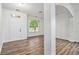 Bright living room boasts wood-look flooring, natural light, and a freshly painted neutral color palette at 7454 Silver Arrow Se Trl, Austell, GA 30168