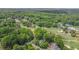 Breathtaking aerial view showcasing lush golf course, tennis courts, and tree-lined properties in a serene setting at 12080 Mountain Laurel Dr, Roswell, GA 30075