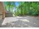Backyard featuring a large patio area and mature trees at 12080 Mountain Laurel Dr, Roswell, GA 30075