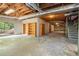 Spacious unfinished basement with a sliding door to the outside and built-in shelving units at 12080 Mountain Laurel Dr, Roswell, GA 30075