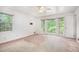 Bright bedroom with large windows allowing natural light, featuring neutral walls and a ceiling fan at 12080 Mountain Laurel Dr, Roswell, GA 30075