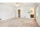 Bedroom with doorway to ensuite bath, featuring neutral walls and carpet at 12080 Mountain Laurel Dr, Roswell, GA 30075