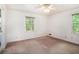 Bedroom with a large window and neutral walls, carpet flooring, and good natural light at 12080 Mountain Laurel Dr, Roswell, GA 30075