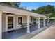 Charming club house with covered outdoor seating and tennis shop access, ideal for relaxation and recreation at 12080 Mountain Laurel Dr, Roswell, GA 30075