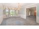 Elegant dining room with a bay window, chandelier, and wallpaper at 12080 Mountain Laurel Dr, Roswell, GA 30075