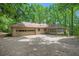 Back exterior view of home with garage, patio, and sunroom at 12080 Mountain Laurel Dr, Roswell, GA 30075