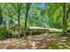 Charming single-story home with lush landscaping and mature trees at 12080 Mountain Laurel Dr, Roswell, GA 30075