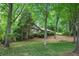 Well-maintained single-story home with mature trees, landscaping, and a lush lawn at 12080 Mountain Laurel Dr, Roswell, GA 30075