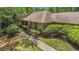 Attractive single-story home with a well-manicured lawn, lush shrubbery, and inviting walkway at 12080 Mountain Laurel Dr, Roswell, GA 30075