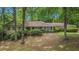 Charming home with a well-maintained front yard and mature trees, offering a tranquil and inviting curb appeal at 12080 Mountain Laurel Dr, Roswell, GA 30075