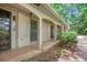 Charming covered front porch with white pillars and brick accents at 12080 Mountain Laurel Dr, Roswell, GA 30075