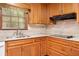 Kitchen sink and countertop with wood cabinets, and tile backsplash at 12080 Mountain Laurel Dr, Roswell, GA 30075