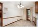 Eat-in kitchen features tile flooring, wood cabinets, and exterior door at 12080 Mountain Laurel Dr, Roswell, GA 30075