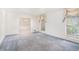 Spacious living room with blue carpet, decorative curtains, and lots of natural light at 12080 Mountain Laurel Dr, Roswell, GA 30075