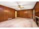 Spacious living room featuring paneled walls and brick fireplace at 12080 Mountain Laurel Dr, Roswell, GA 30075