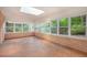 Sunroom featuring multiple windows, brick walls, and brick tile floor at 12080 Mountain Laurel Dr, Roswell, GA 30075
