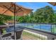 Scenic view of well-maintained tennis courts with outdoor seating, perfect for enjoying a match at 12080 Mountain Laurel Dr, Roswell, GA 30075