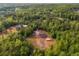 An aerial view of a house surrounded by lush greenery, featuring a spacious lot and a peaceful, private setting at 130 Williams Rd, Villa Rica, GA 30180