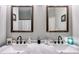 Bathroom with double sinks with white marble counter tops and dark wood cabinets at 130 Williams Rd, Villa Rica, GA 30180