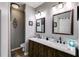 Bathroom with dark wood cabinets, light grey walls, and double sinks with large mirrors at 130 Williams Rd, Villa Rica, GA 30180