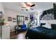 Well lit bedroom with a bed, ceiling fan, vanity mirror and shelving at 130 Williams Rd, Villa Rica, GA 30180