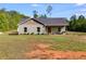Charming single-story home with a covered front porch, green siding, and well-maintained landscaping at 130 Williams Rd, Villa Rica, GA 30180