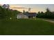 Scenic view of single story home with a well-manicured lawn and mature trees at sunset at 130 Williams Rd, Villa Rica, GA 30180