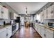 Modern kitchen with white cabinetry, stainless steel appliances, granite countertops, and wood-look floors at 130 Williams Rd, Villa Rica, GA 30180