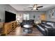 Spacious living room with comfortable leather sofa, ceiling fan, and a view of the kitchen at 130 Williams Rd, Villa Rica, GA 30180