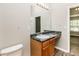 Bright bathroom with large mirror, black marble counter, and wood-look floor at 155 Oak Terrace Dr, Covington, GA 30016