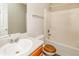 Clean bathroom featuring a tub shower combo, wooden toilet seat, and undermount sink at 155 Oak Terrace Dr, Covington, GA 30016