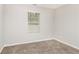 Bedroom featuring neutral walls, carpeted flooring, and a window at 155 Oak Terrace Dr, Covington, GA 30016