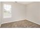 Bedroom features neutral walls and carpet, and a window at 155 Oak Terrace Dr, Covington, GA 30016