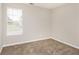 Bedroom featuring neutral walls, carpeted flooring, and a window at 155 Oak Terrace Dr, Covington, GA 30016