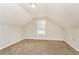 Bonus room features neutral walls and carpet, and a window at 155 Oak Terrace Dr, Covington, GA 30016