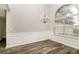 Elegant dining room features wainscoting, a modern chandelier, and a large window at 155 Oak Terrace Dr, Covington, GA 30016